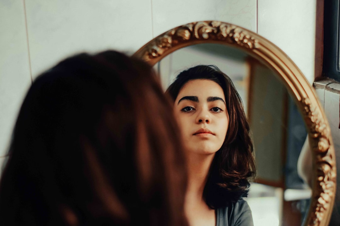 A woman looking at her reflection in a mirror